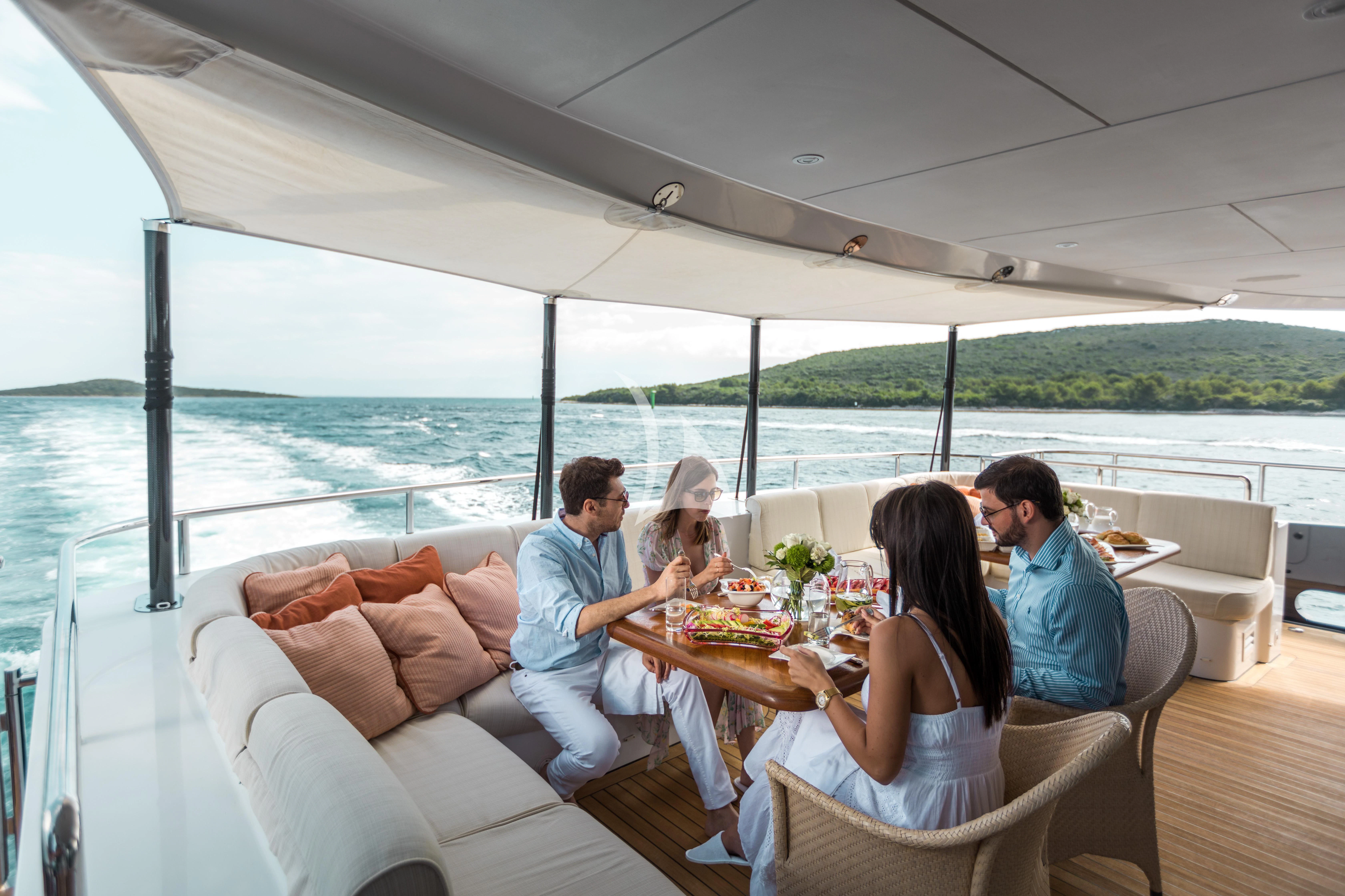 a family having dinner on the balcony aboard AGRAM Yacht for Charter