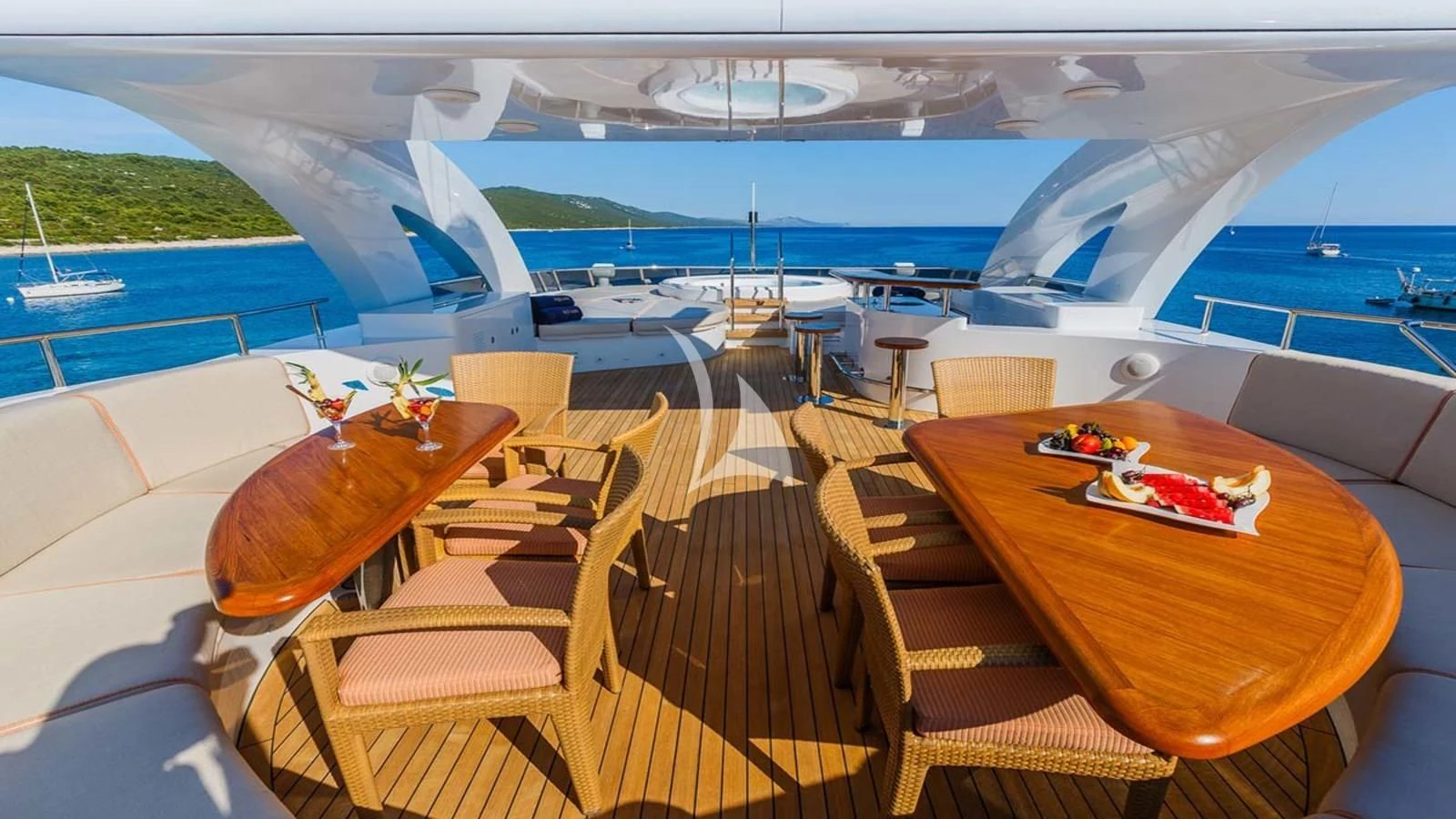 a room with a table chairs and a view of the water aboard AGRAM Yacht for Charter