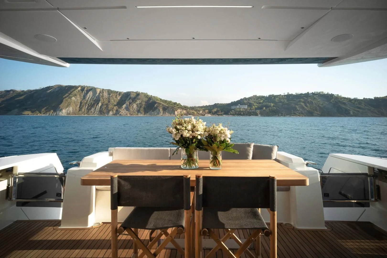 a table with flowers on it aboard ALVEARE Yacht for Sale