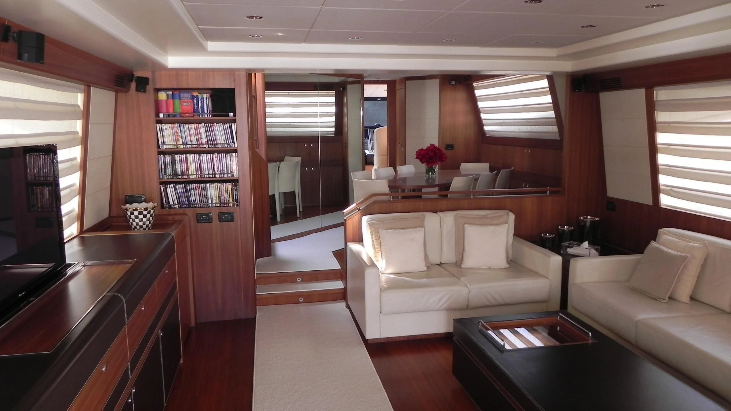 a living room with a white couch and a coffee table aboard WEDGE THREE Yacht for Sale