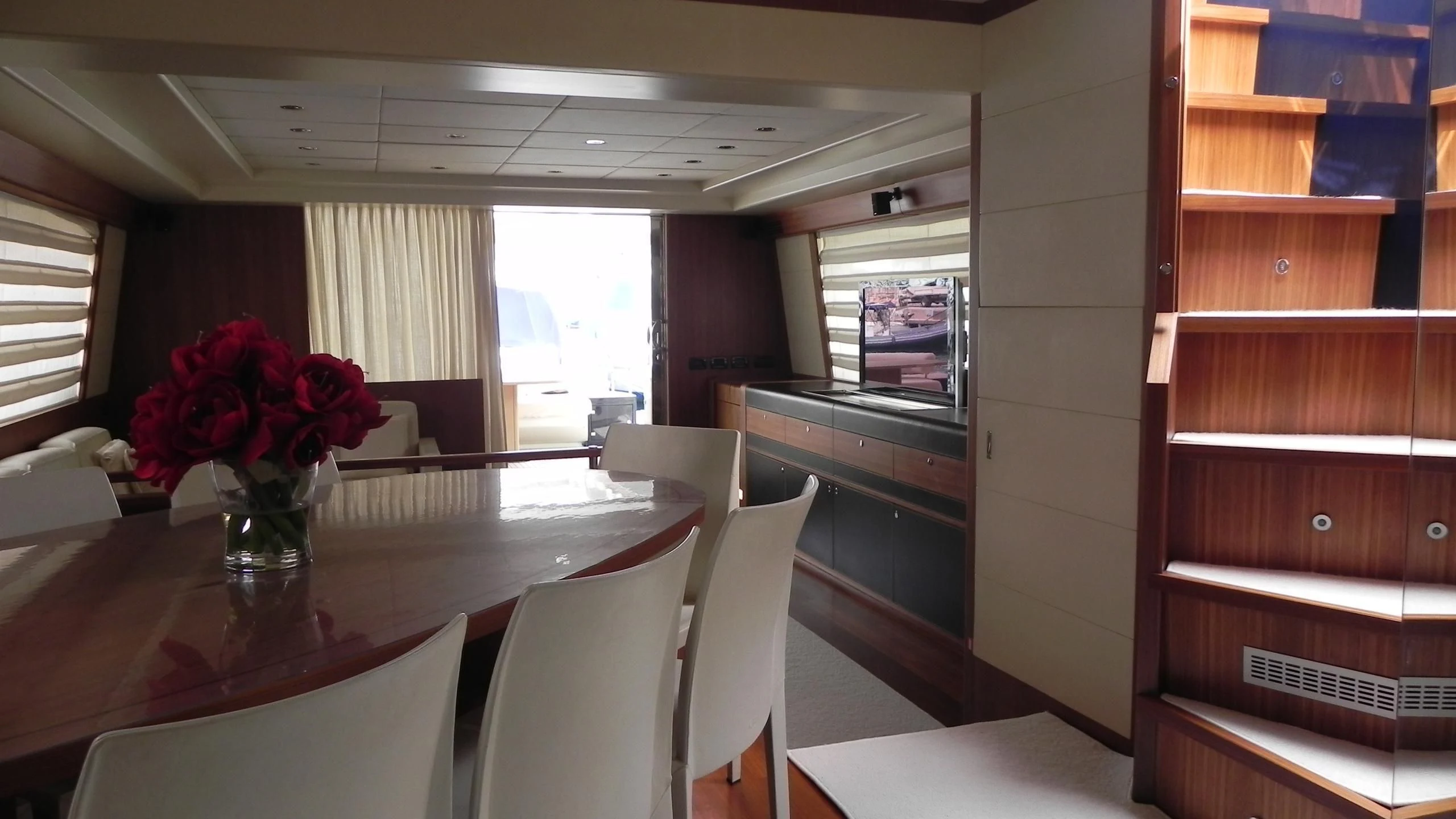 a room with a table and chairs aboard WEDGE THREE Yacht for Sale