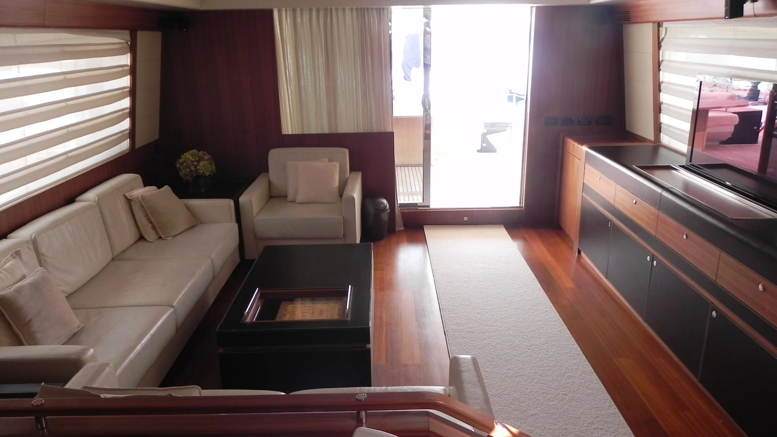 a living room with a couch and a coffee table aboard WEDGE THREE Yacht for Sale