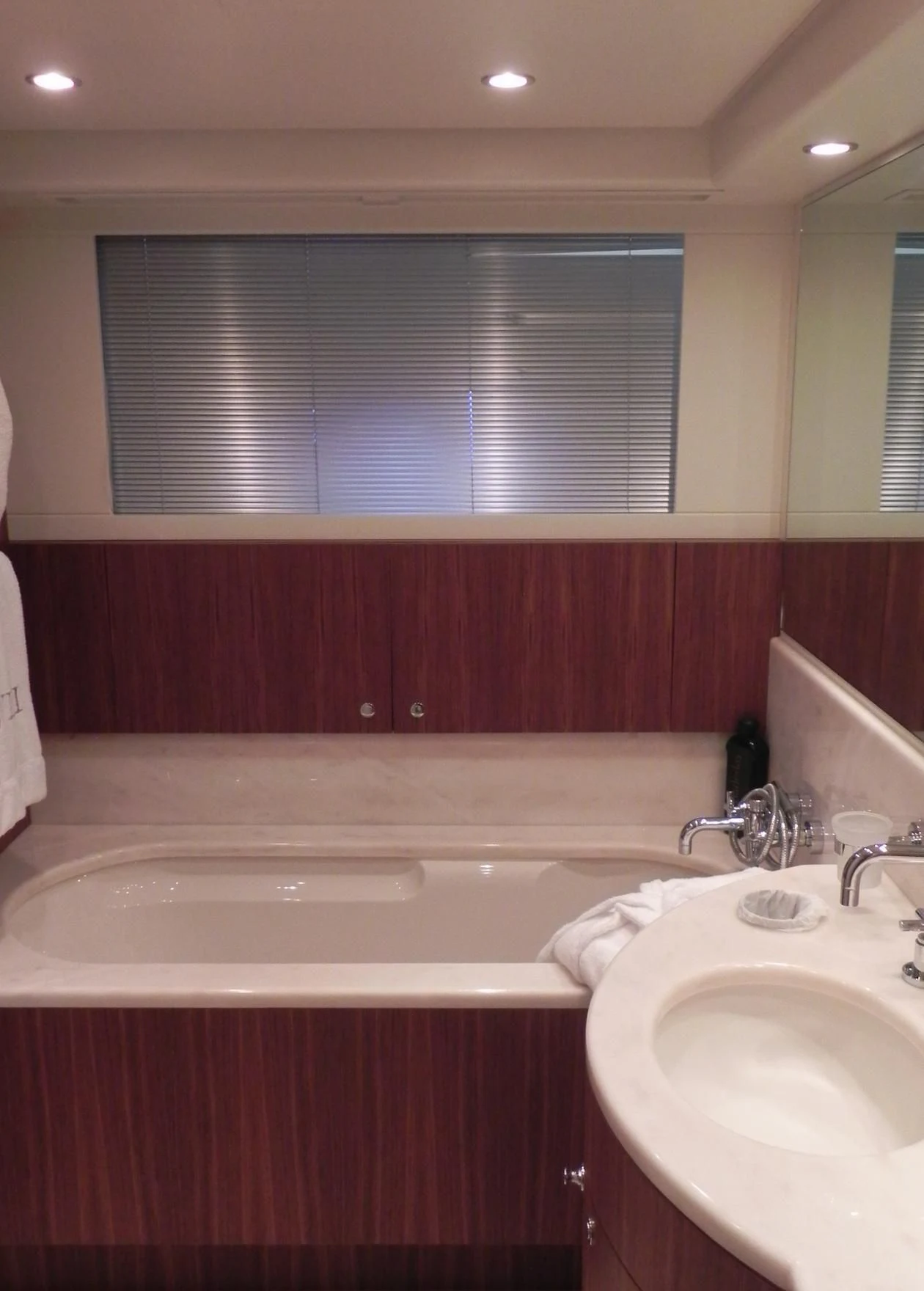 a bathroom with a tub sink and a window aboard WEDGE THREE Yacht for Sale