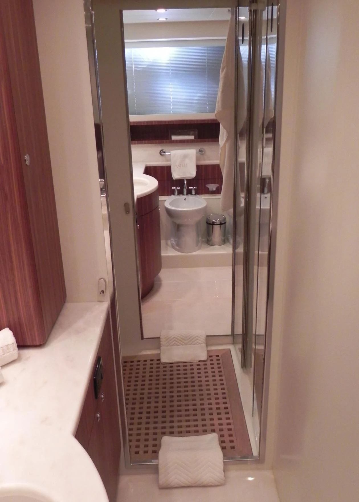a bathroom with a glass shower door aboard WEDGE THREE Yacht for Sale