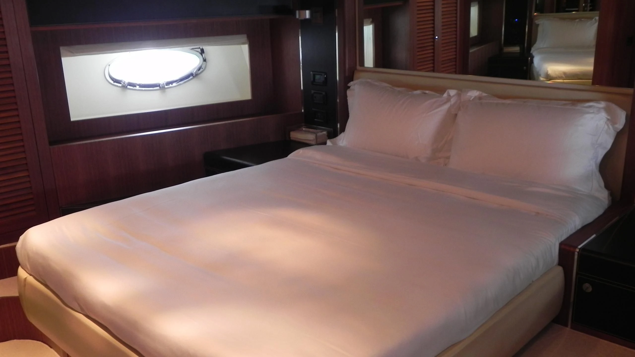 a bed with a white comforter aboard WEDGE THREE Yacht for Sale
