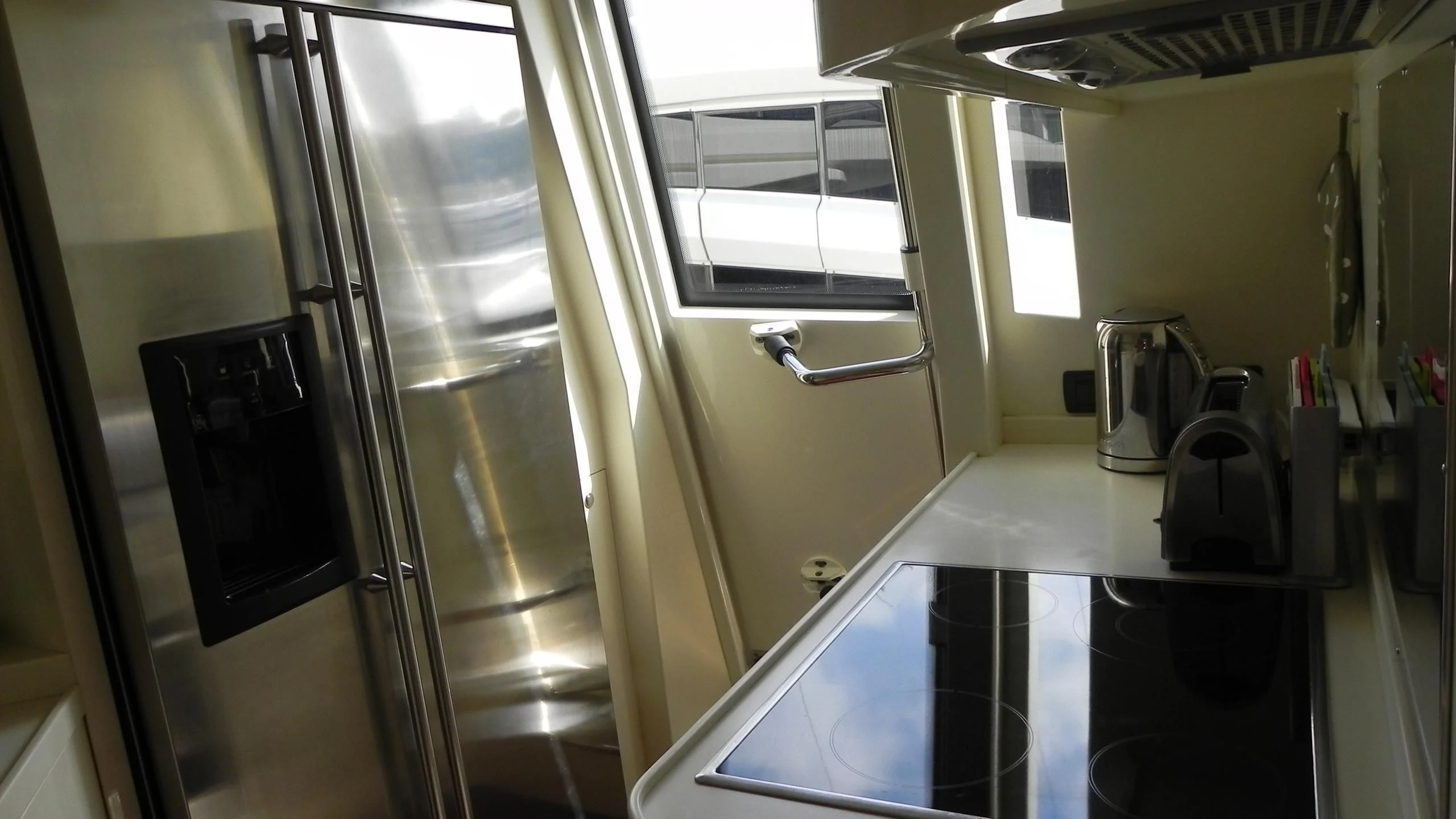 a room with a table and a computer aboard WEDGE THREE Yacht for Sale