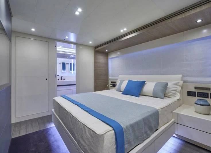 a bed in a room aboard AMAN Yacht for Sale