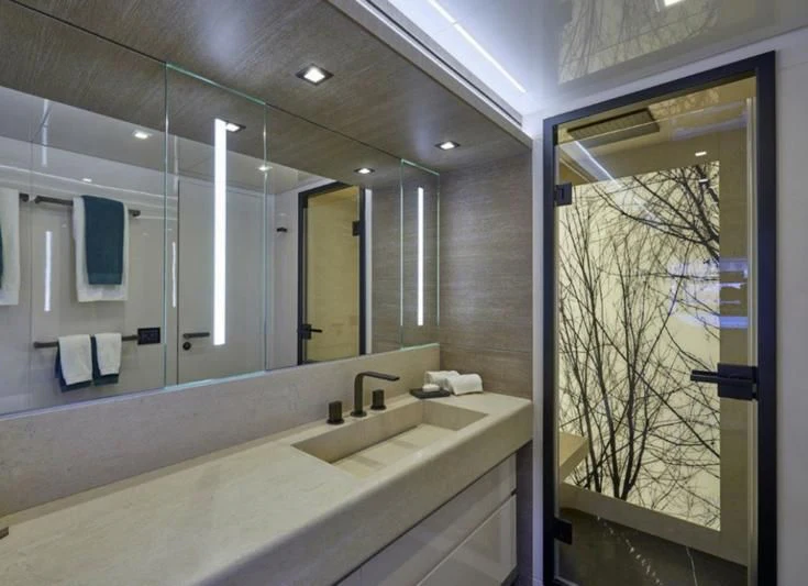 a bathroom with a large mirror aboard AMAN Yacht for Sale