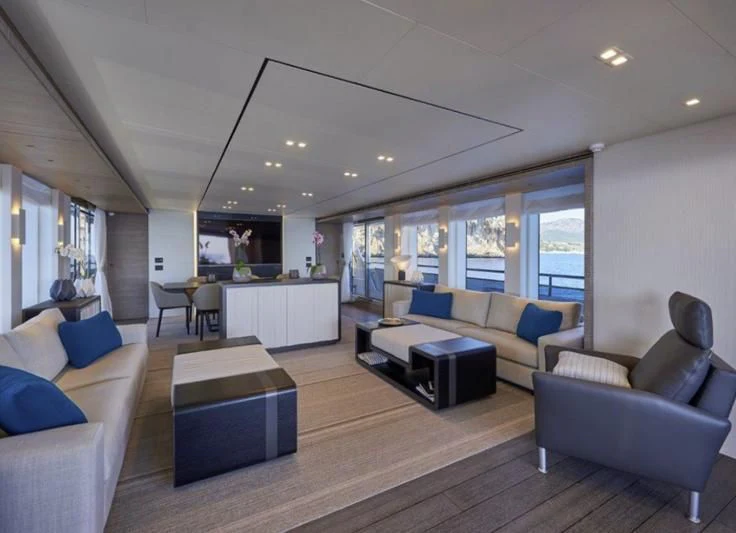 a living room with a couch and a table aboard AMAN Yacht for Sale