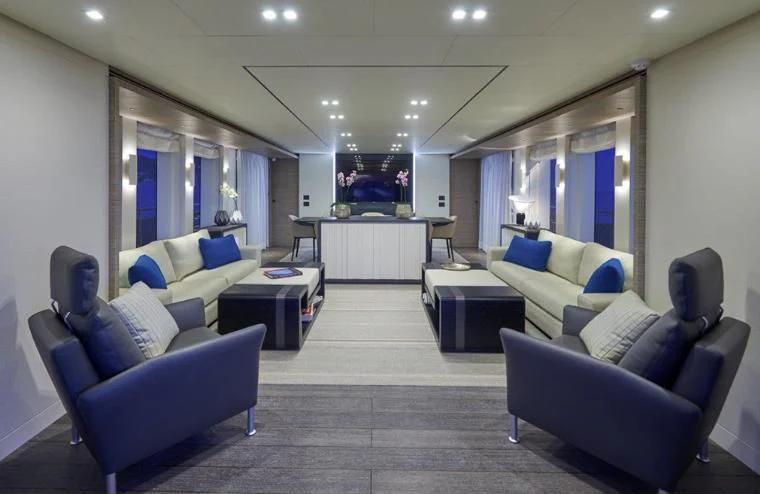 a living room with a couch and a table aboard AMAN Yacht for Sale