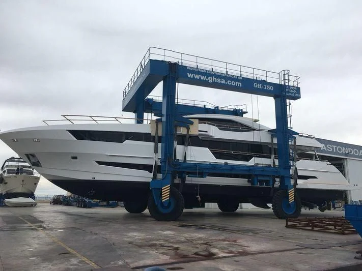 a large blue truck with a trailer aboard AMAN Yacht for Sale