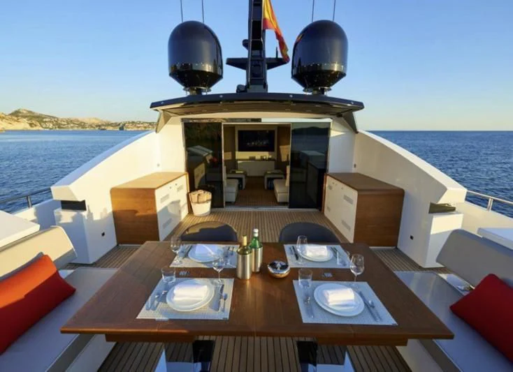 a table with chairs on it aboard AMAN Yacht for Sale