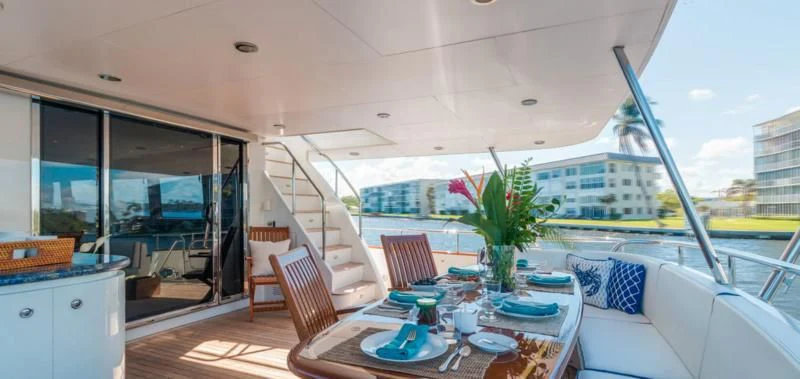 a table with chairs and a plant on it aboard WINDWARD Yacht for Charter