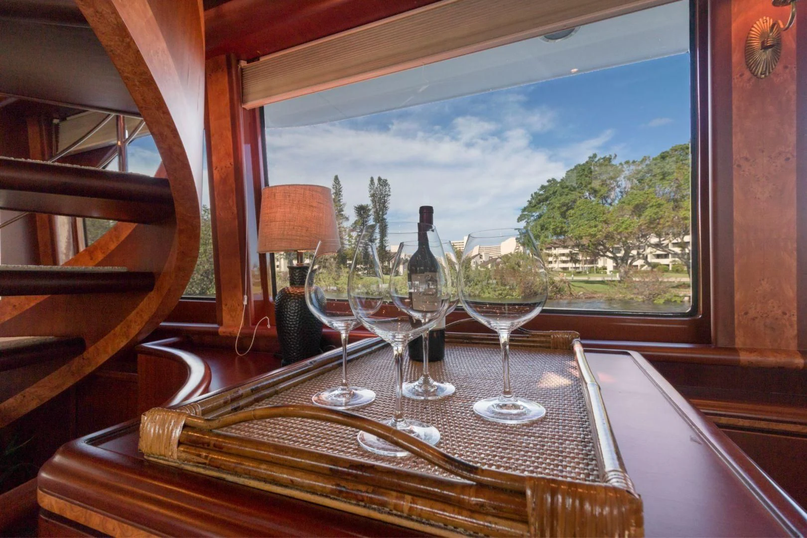 a table with wine glasses and a bottle of wine aboard WINDWARD Yacht for Charter