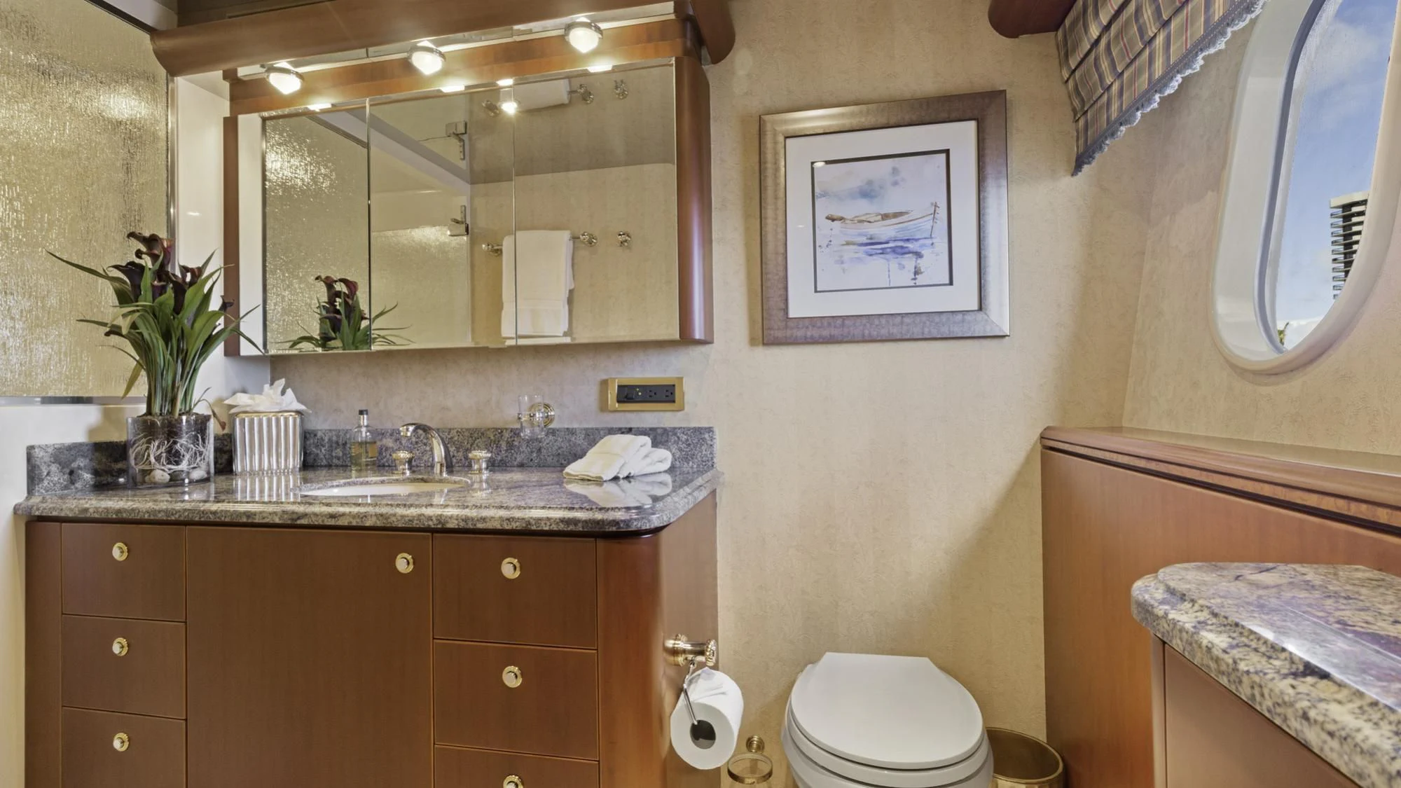 a bathroom with a sink and mirror aboard WINDWARD Yacht for Charter