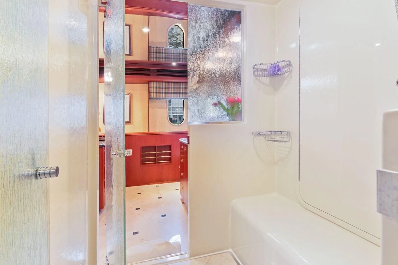 a bathroom with a tub and shower aboard WINDWARD Yacht for Charter