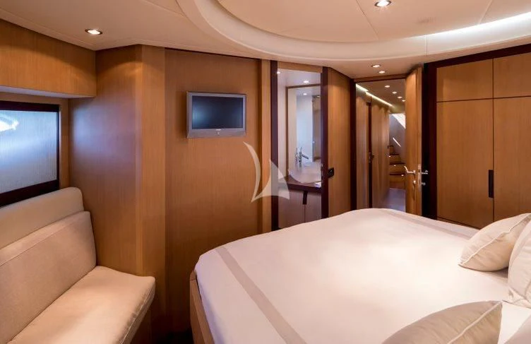 a hotel room with a bed and a television aboard WINDWARD Yacht for Charter