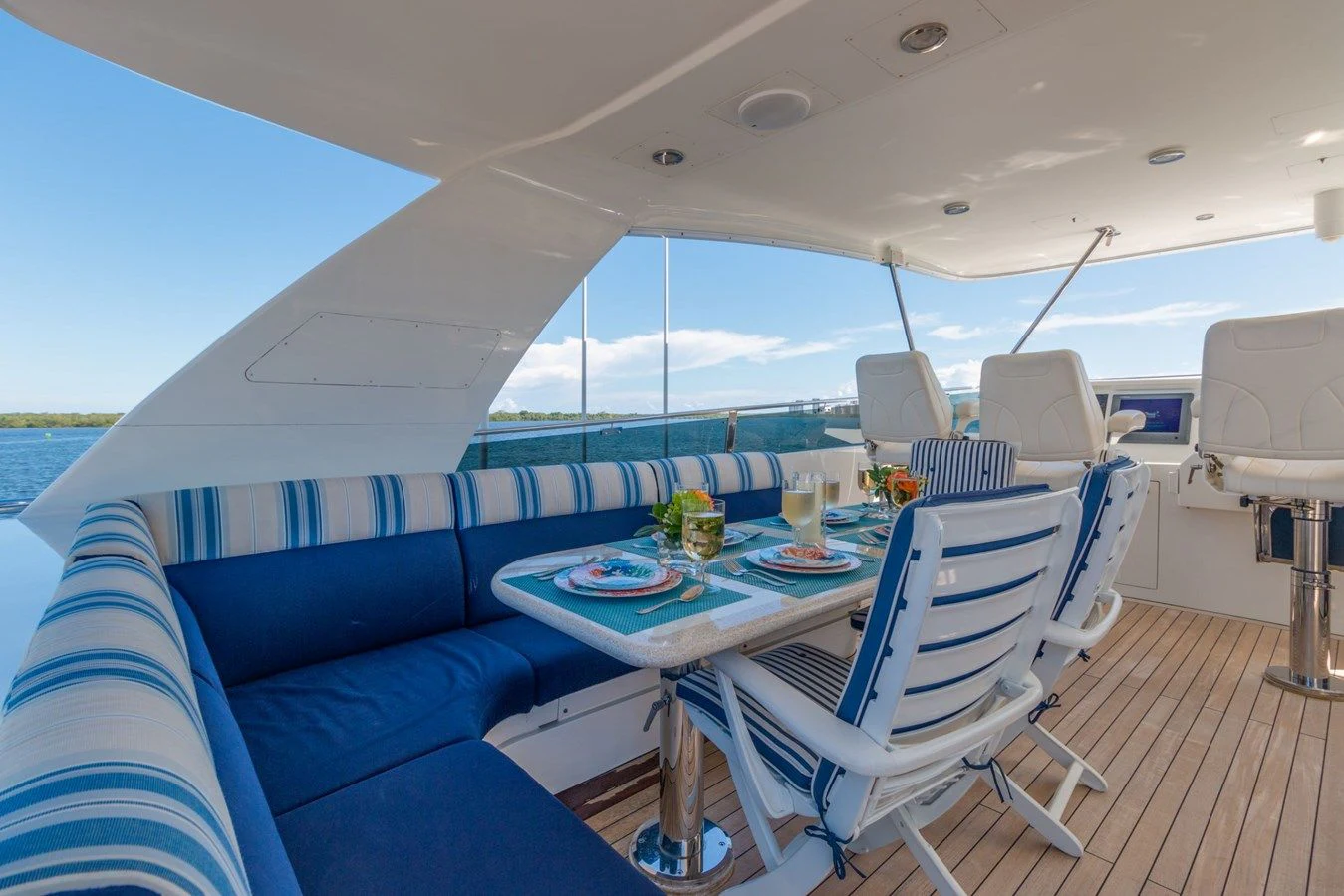 a boat with a table and chairs aboard WINDWARD Yacht for Charter