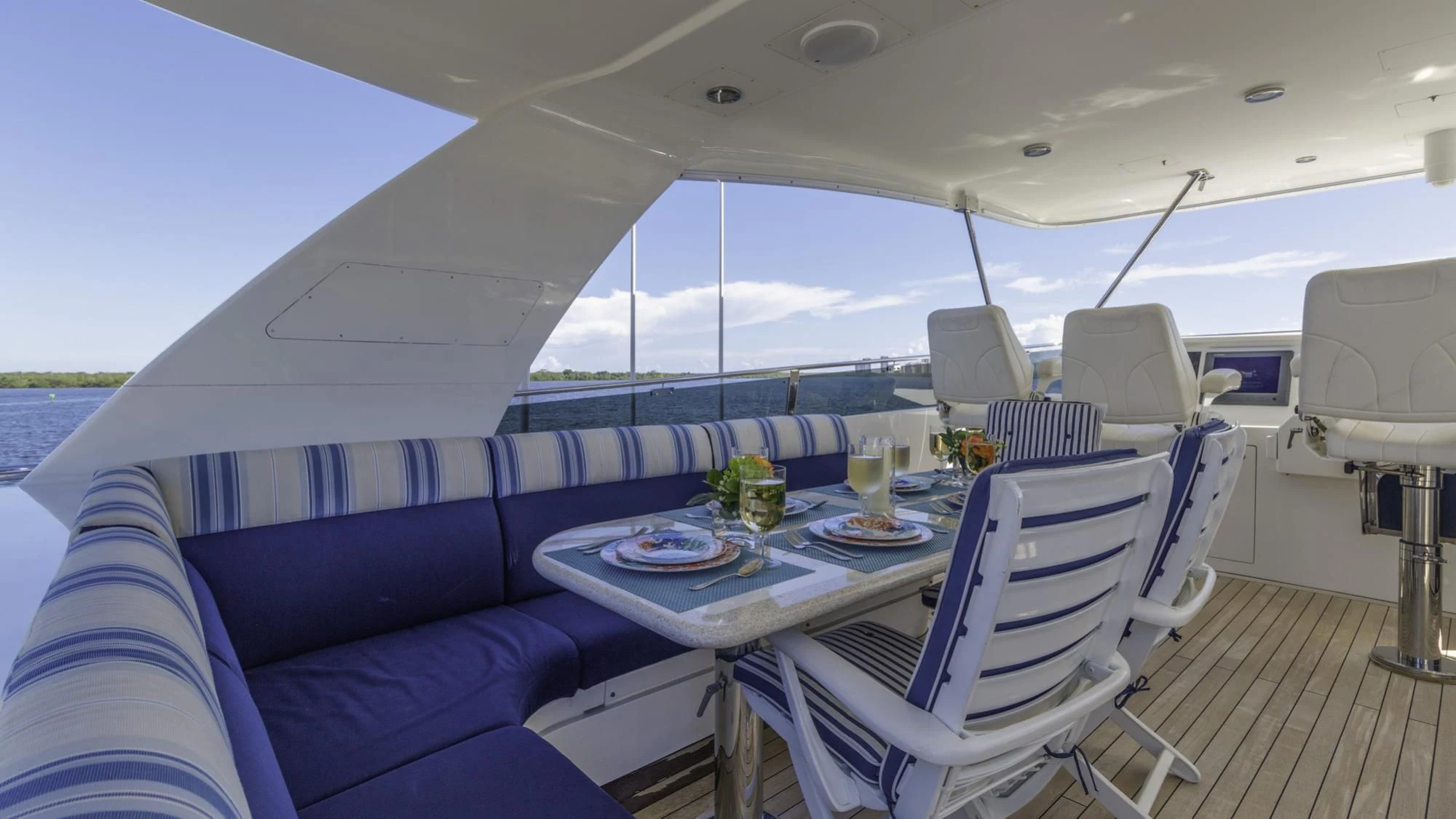 a boat with a table and chairs aboard WINDWARD Yacht for Charter