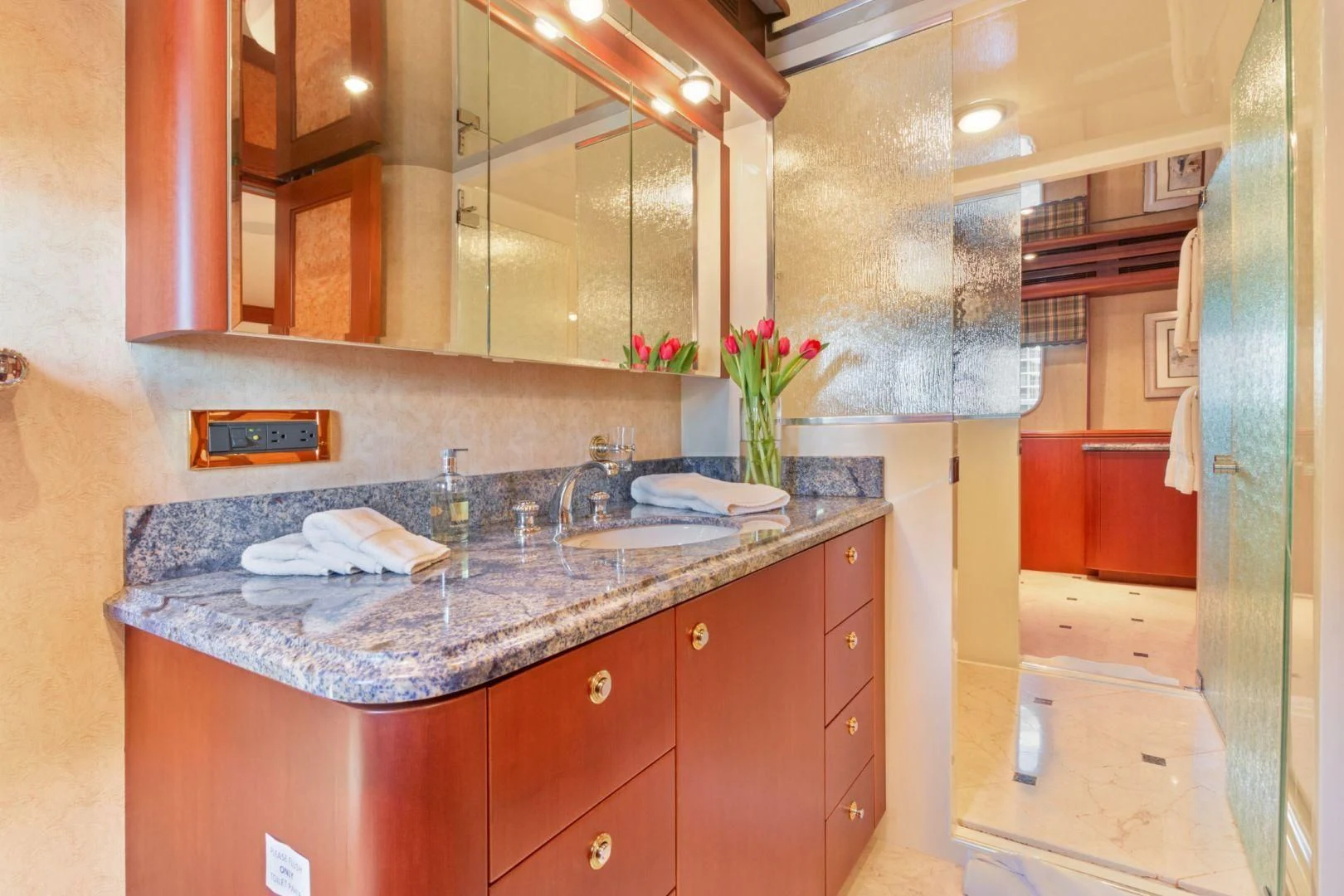 a bathroom with a countertop sink and cabinets aboard WINDWARD Yacht for Charter