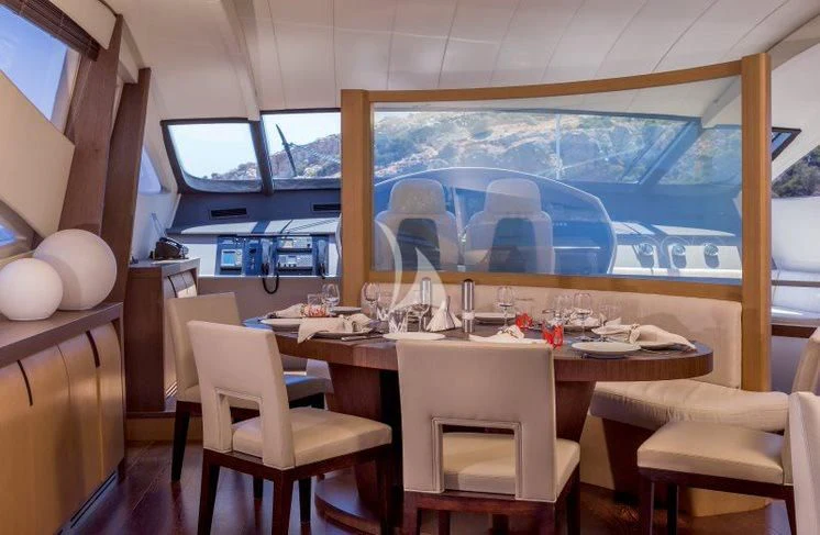 a room with a table and chairs aboard WINDWARD Yacht for Charter