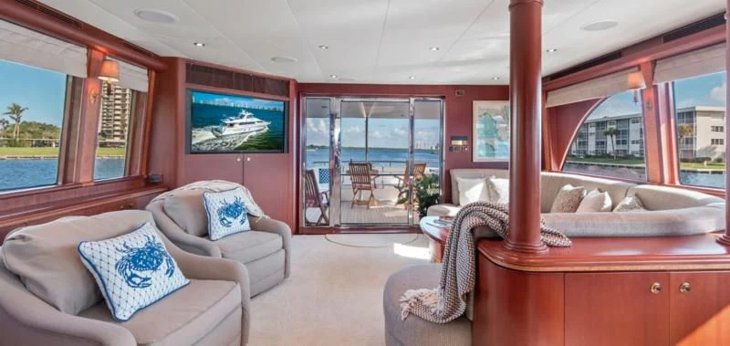 a living room with a large window aboard WINDWARD Yacht for Charter
