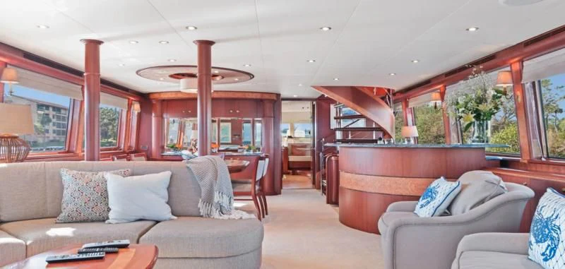 a living room with a couch and a table aboard WINDWARD Yacht for Charter