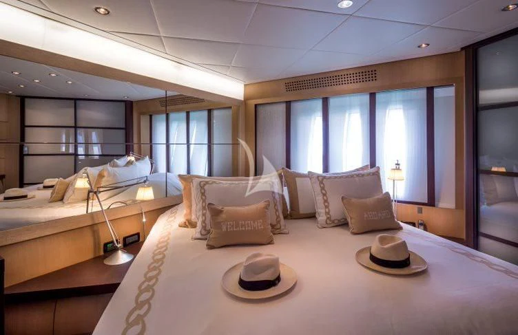 a bed with pillows and a couple of pillows on it aboard WINDWARD Yacht for Charter