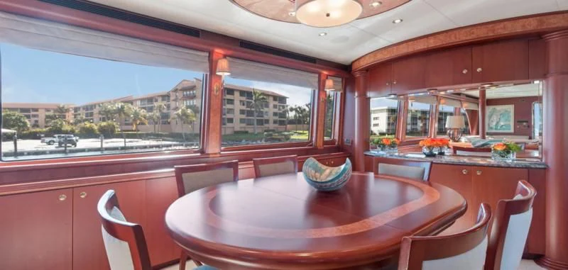 a kitchen with a table and chairs aboard WINDWARD Yacht for Charter