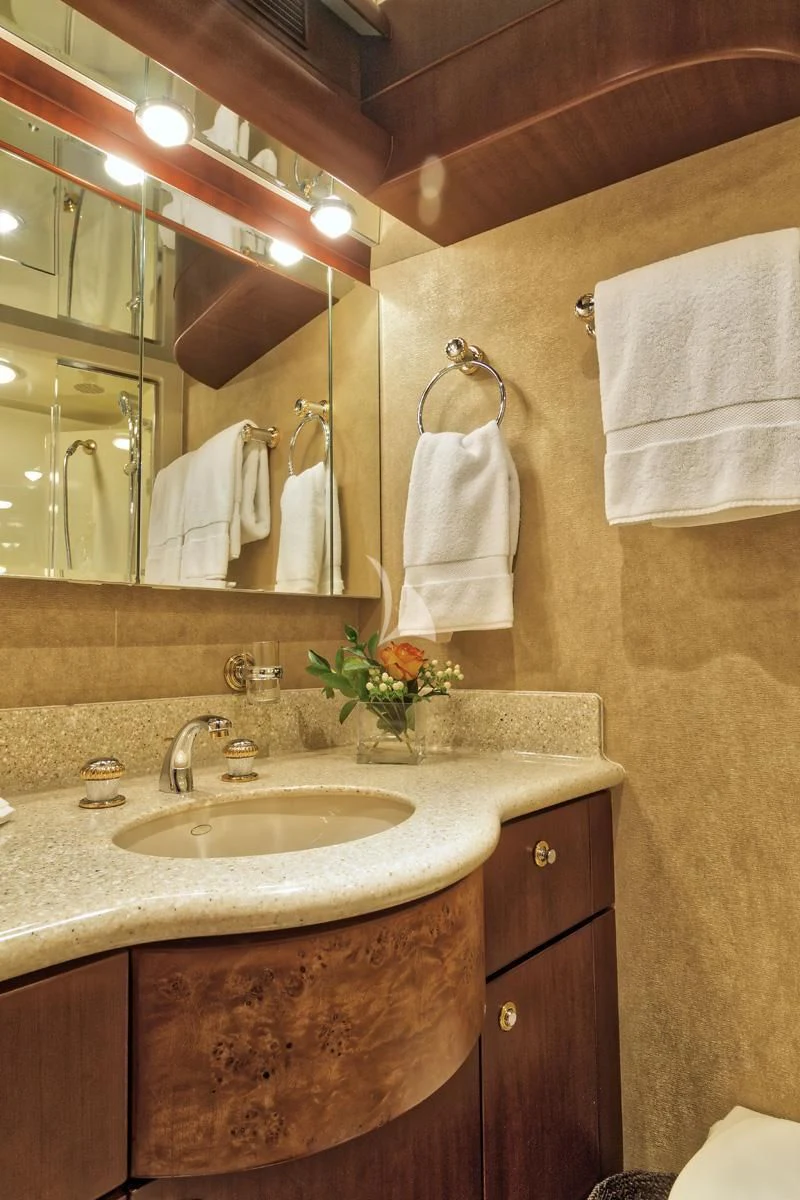 a bathroom with a sink and towels aboard WINDWARD Yacht for Charter