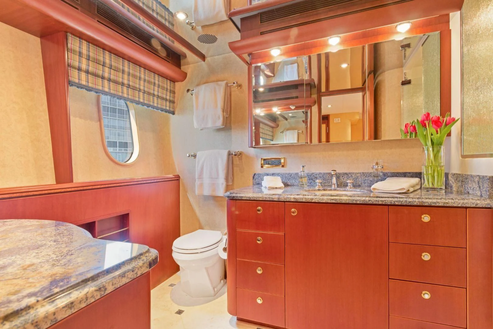 a bathroom with a large mirror aboard WINDWARD Yacht for Charter