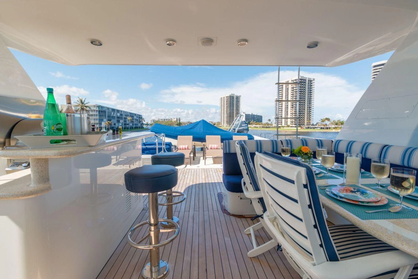 a room with a table chairs and a view of the water aboard WINDWARD Yacht for Charter