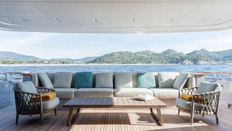 a patio with a table and chairs aboard STONE HILLS Yacht for Sale