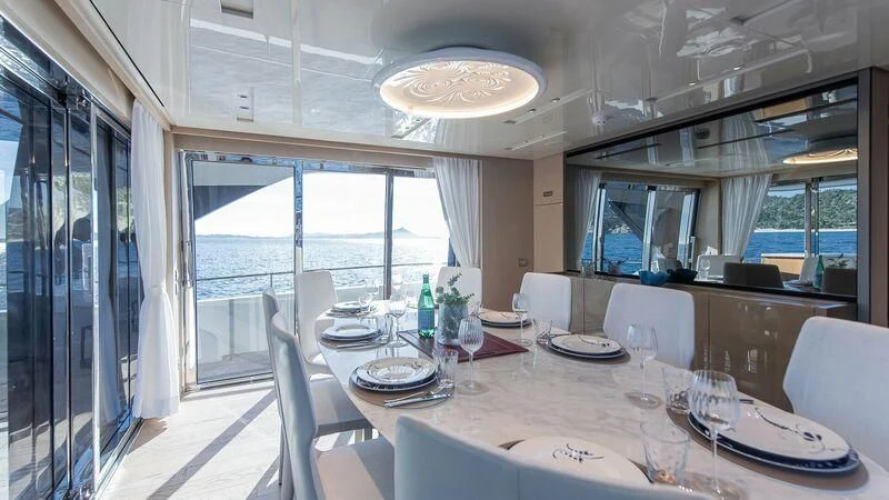 a dining room with a large window aboard STONE HILLS Yacht for Sale
