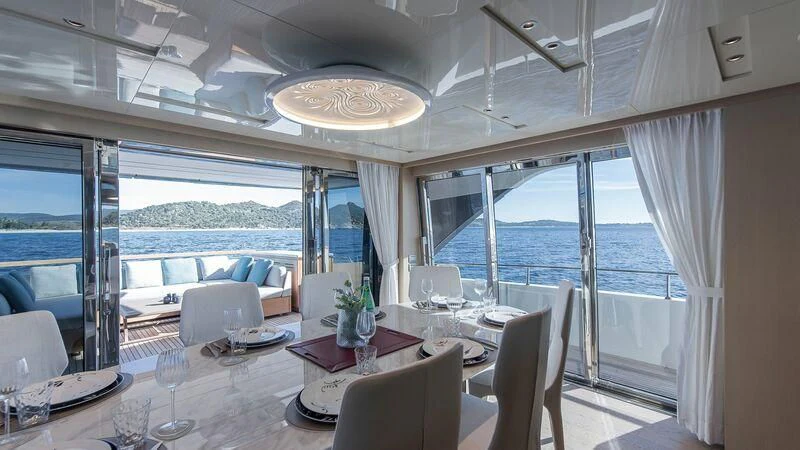 a dining room with a large window aboard STONE HILLS Yacht for Sale