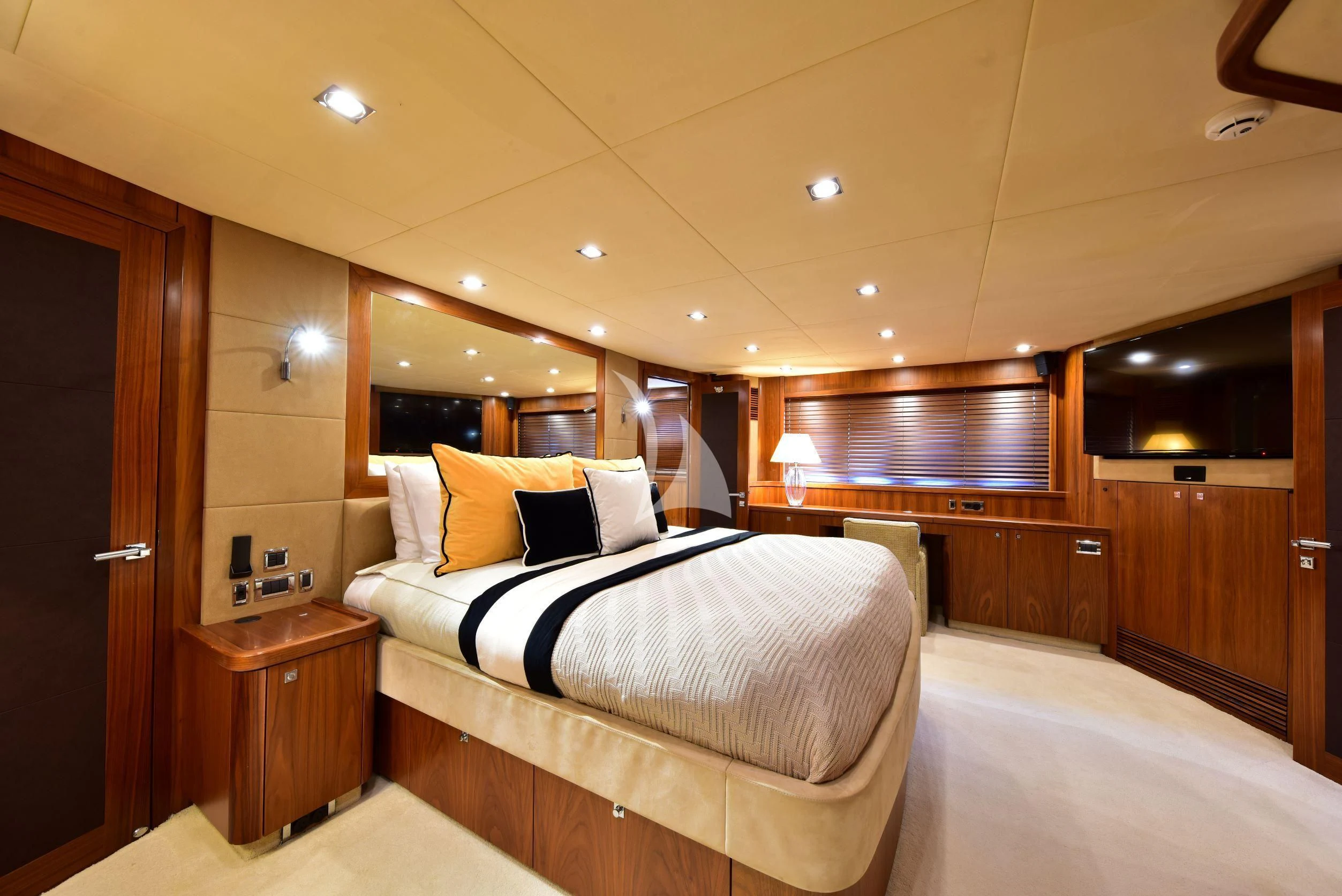 a room with a bed and a mirror aboard CATALANA Yacht for Charter