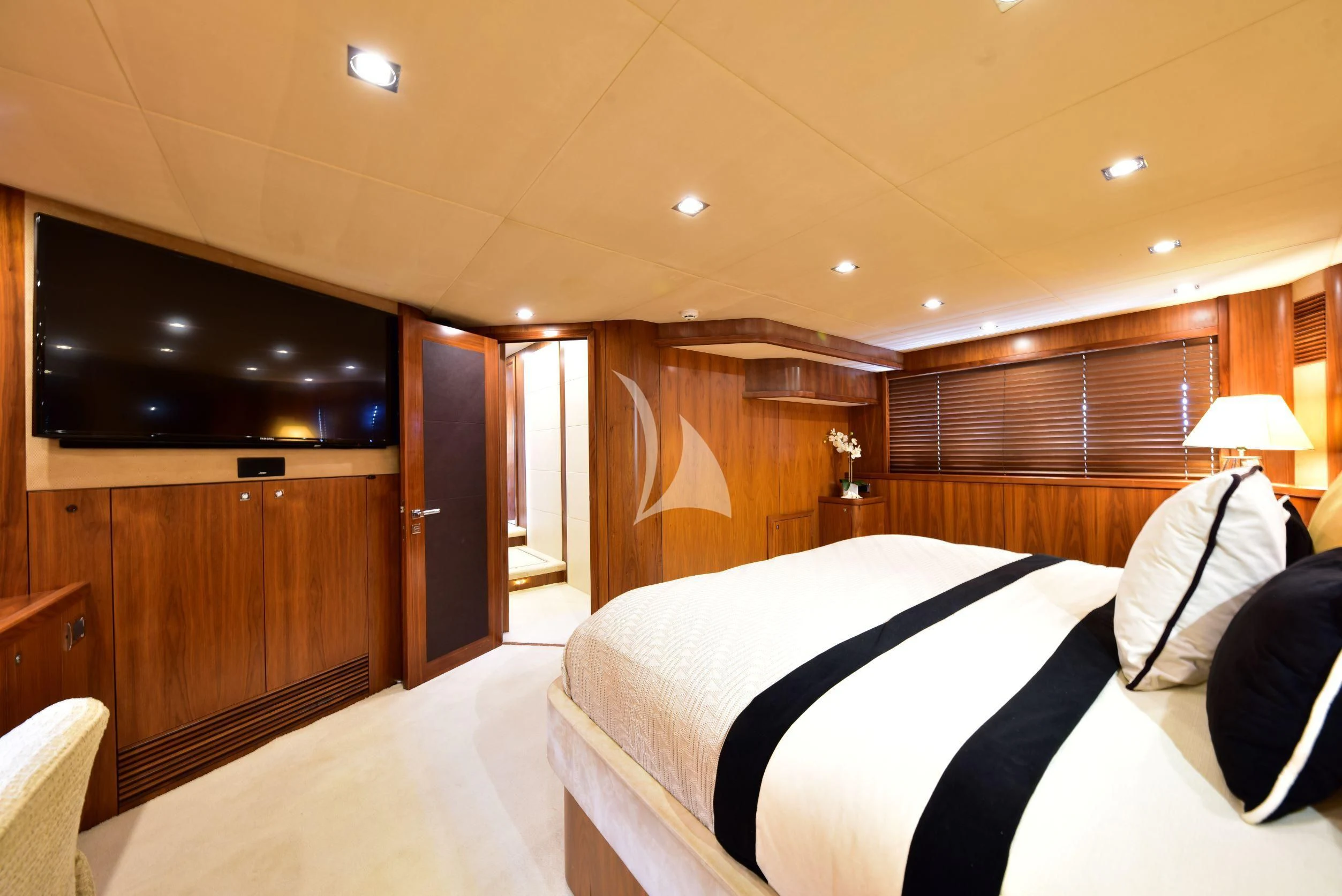 a room with a bed and a television aboard CATALANA Yacht for Charter
