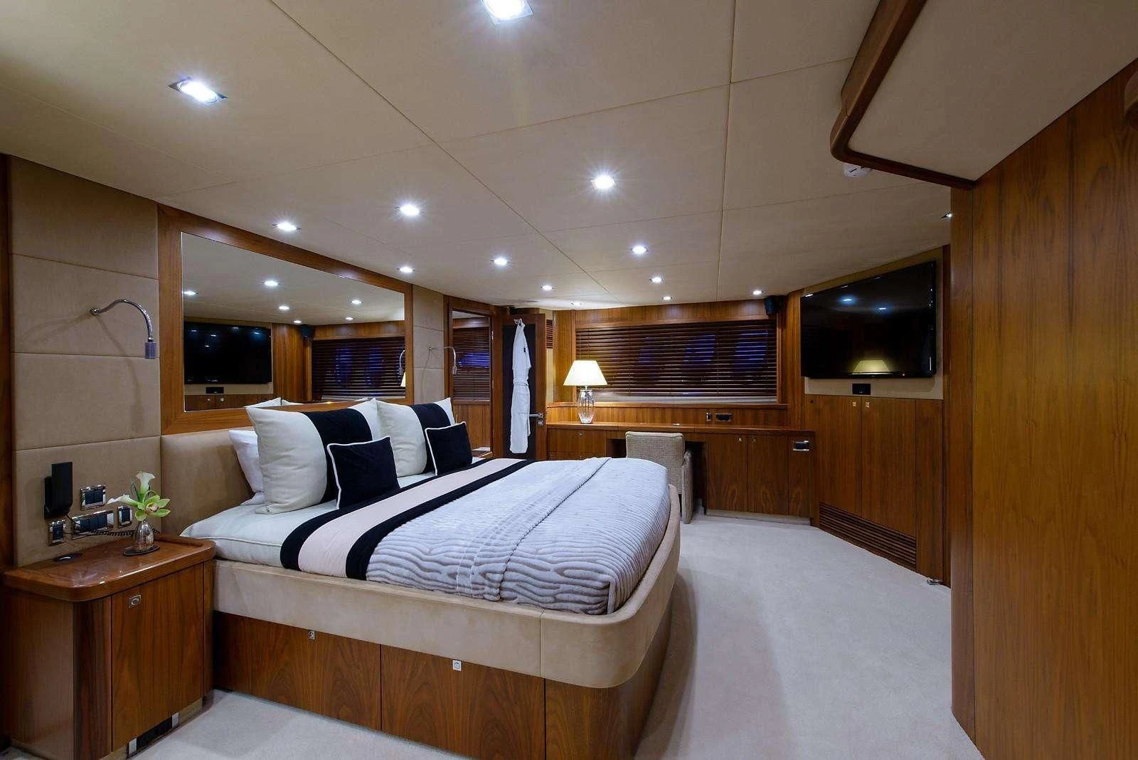 a room with a bed and a tv aboard CATALANA Yacht for Charter