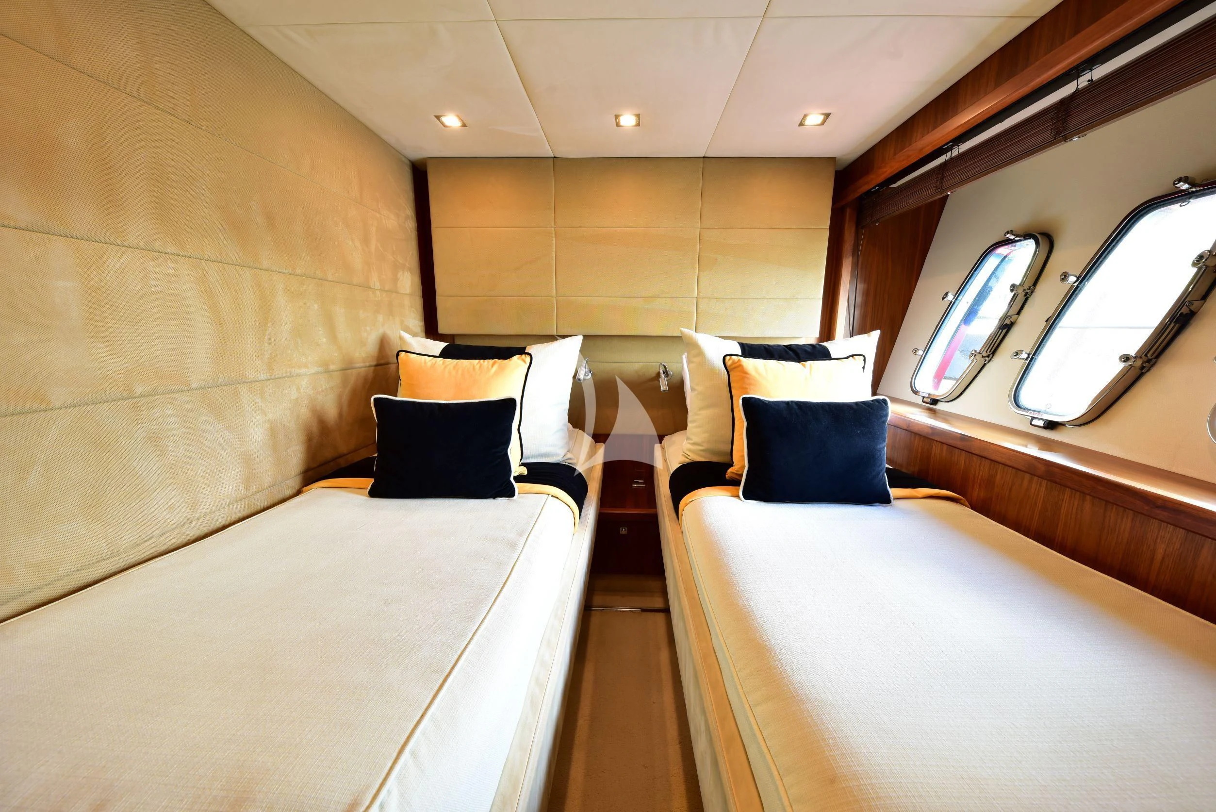 a room with beds and a window aboard CATALANA Yacht for Charter