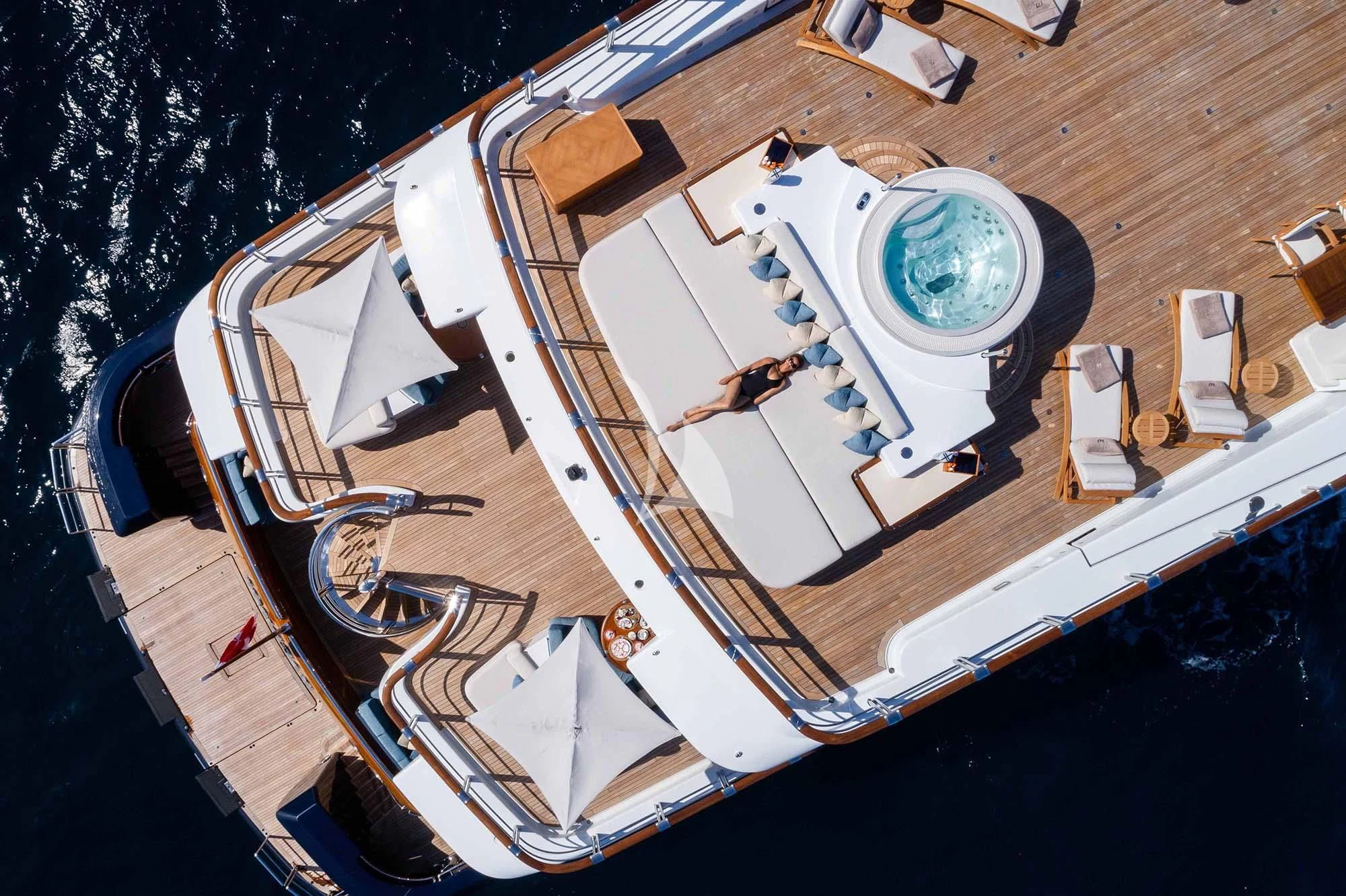 a white and gold boat on a wooden dock aboard WHEELS Yacht for Sale