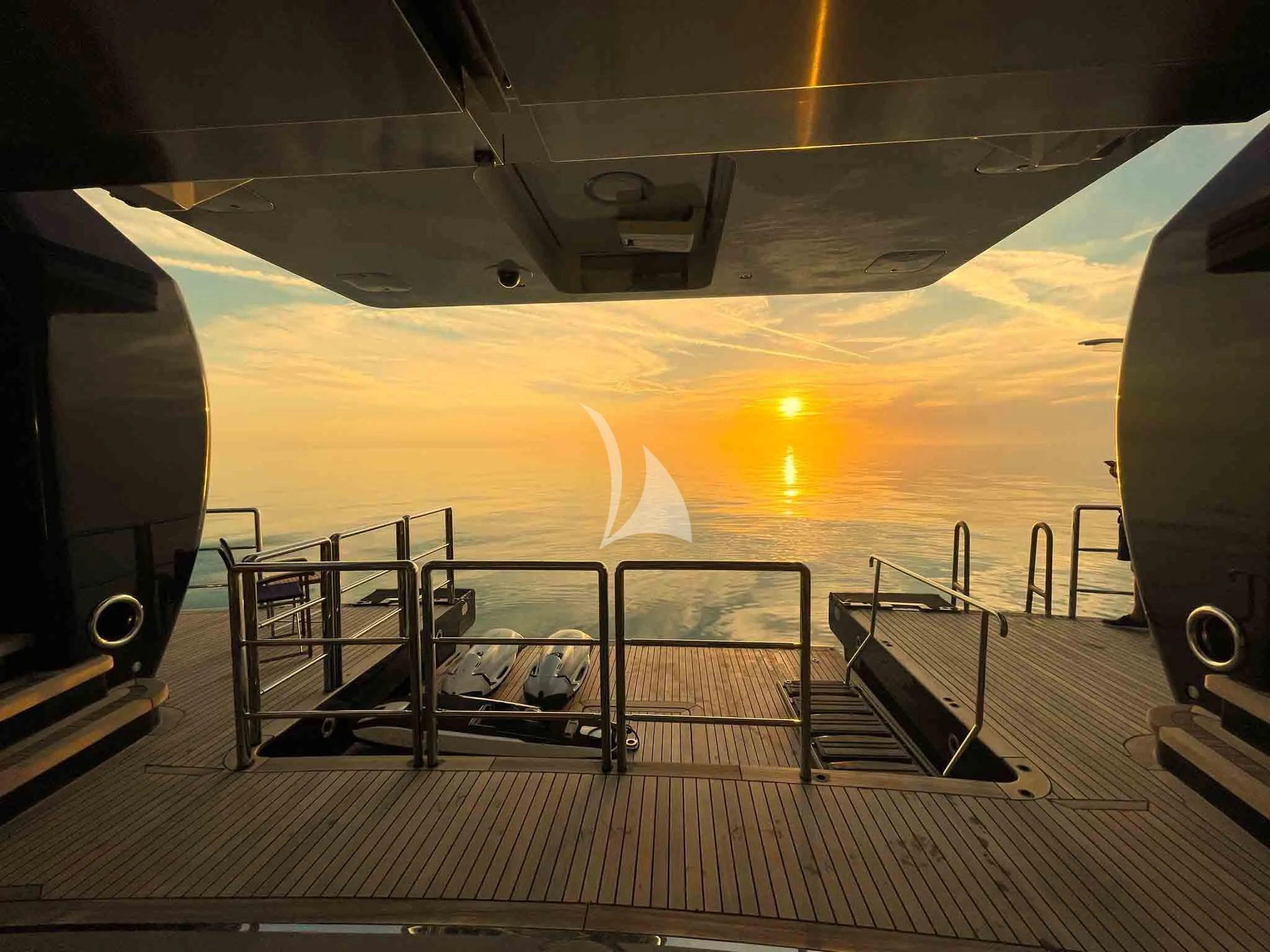 the sun setting over the ocean aboard WHEELS Yacht for Sale