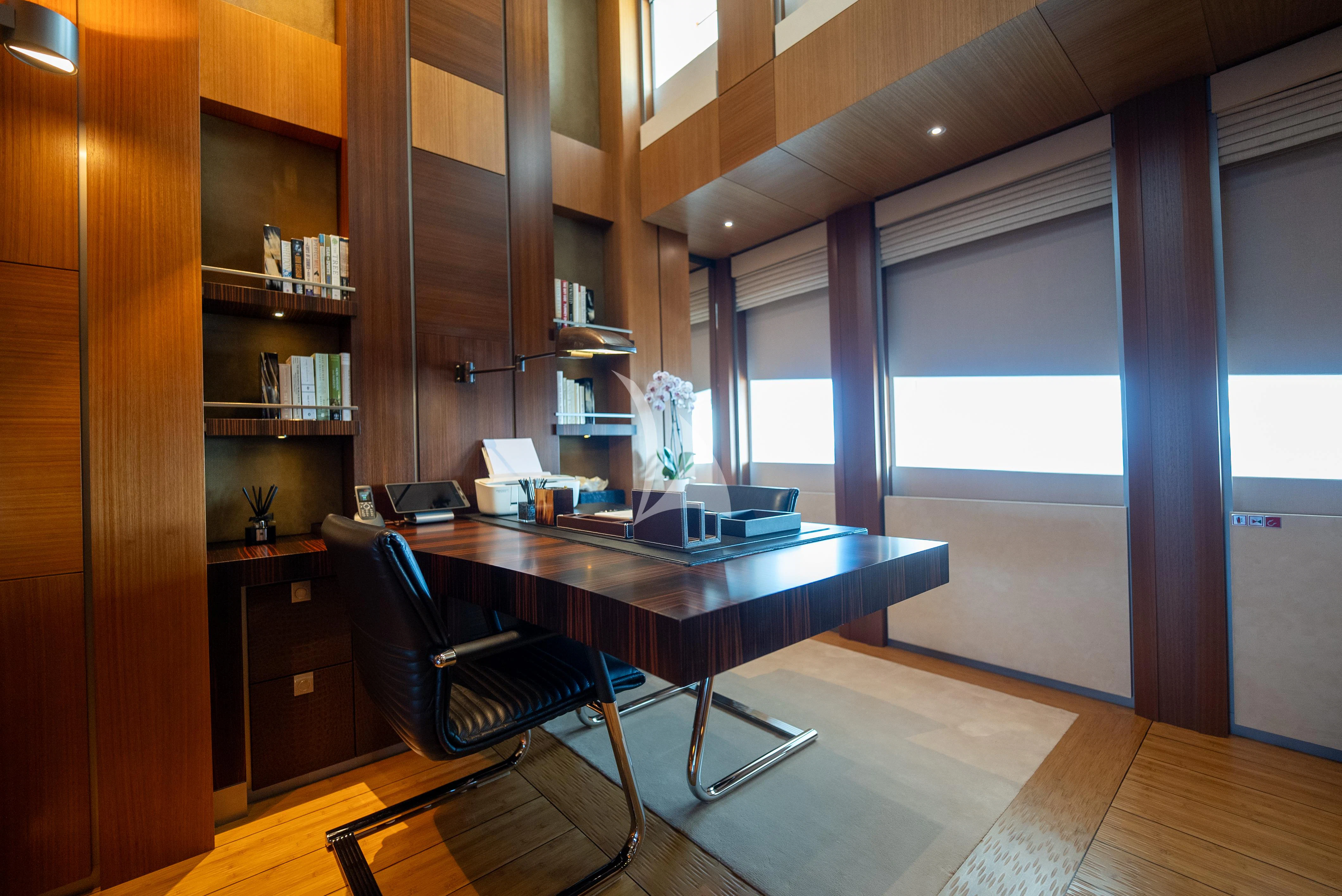 a room with a table and chairs aboard WHEELS Yacht for Sale