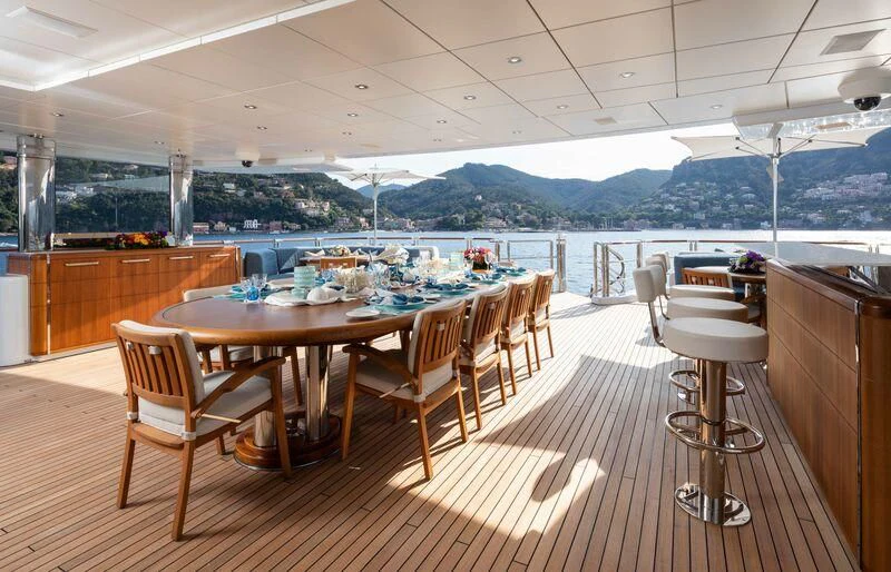 a large room with tables and chairs aboard WHEELS Yacht for Sale