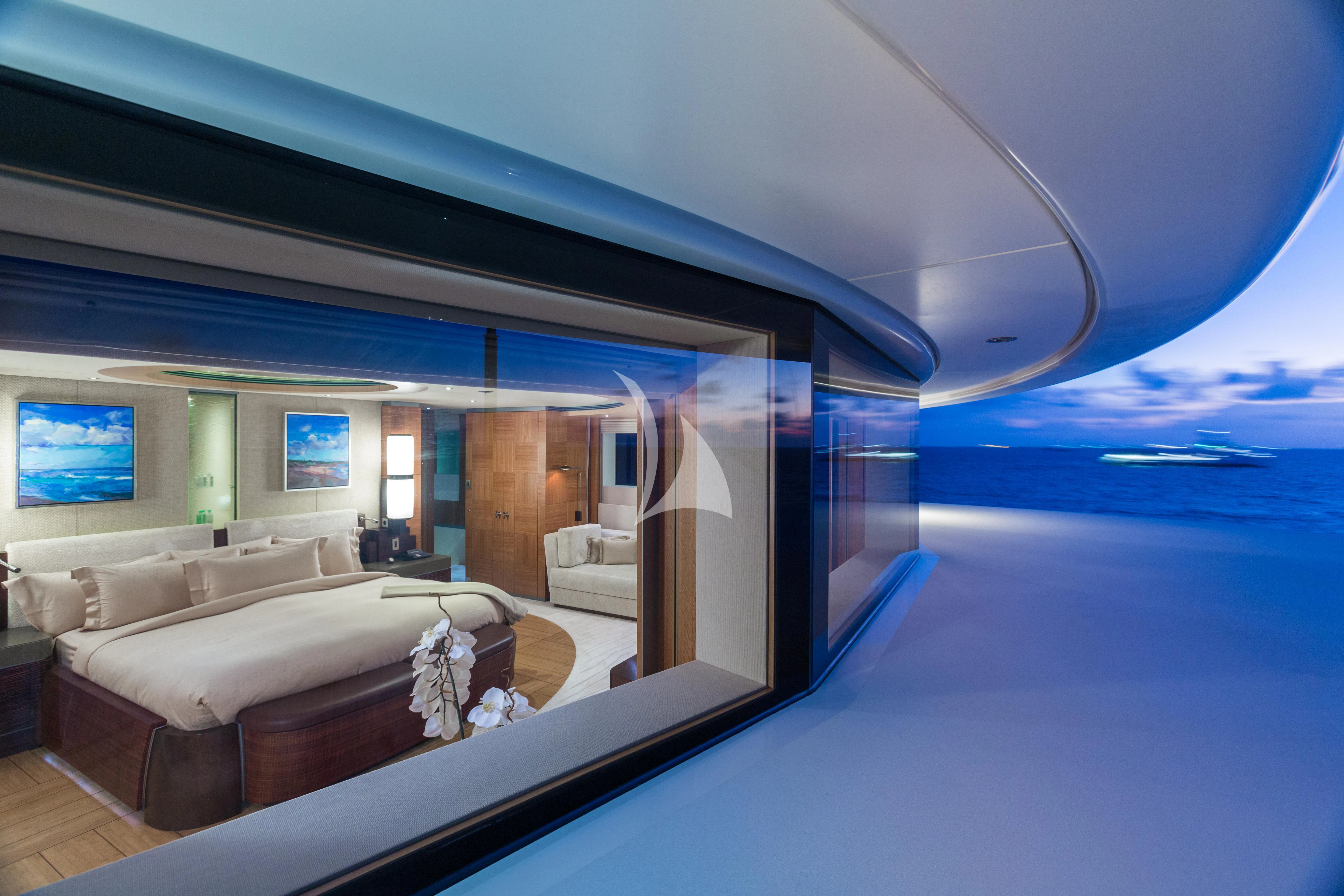 a large room with a bed and a large window aboard WHEELS Yacht for Sale