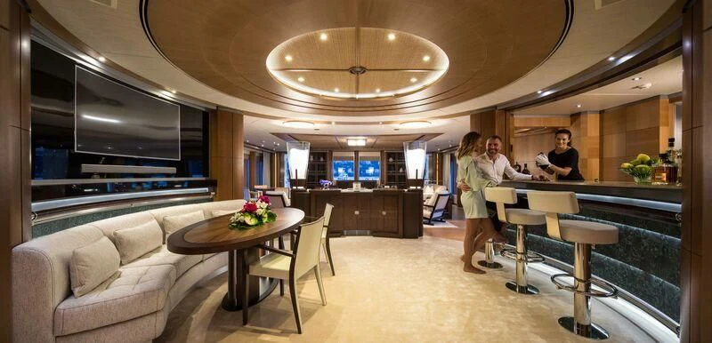 a couple of people in a room aboard WHEELS Yacht for Sale
