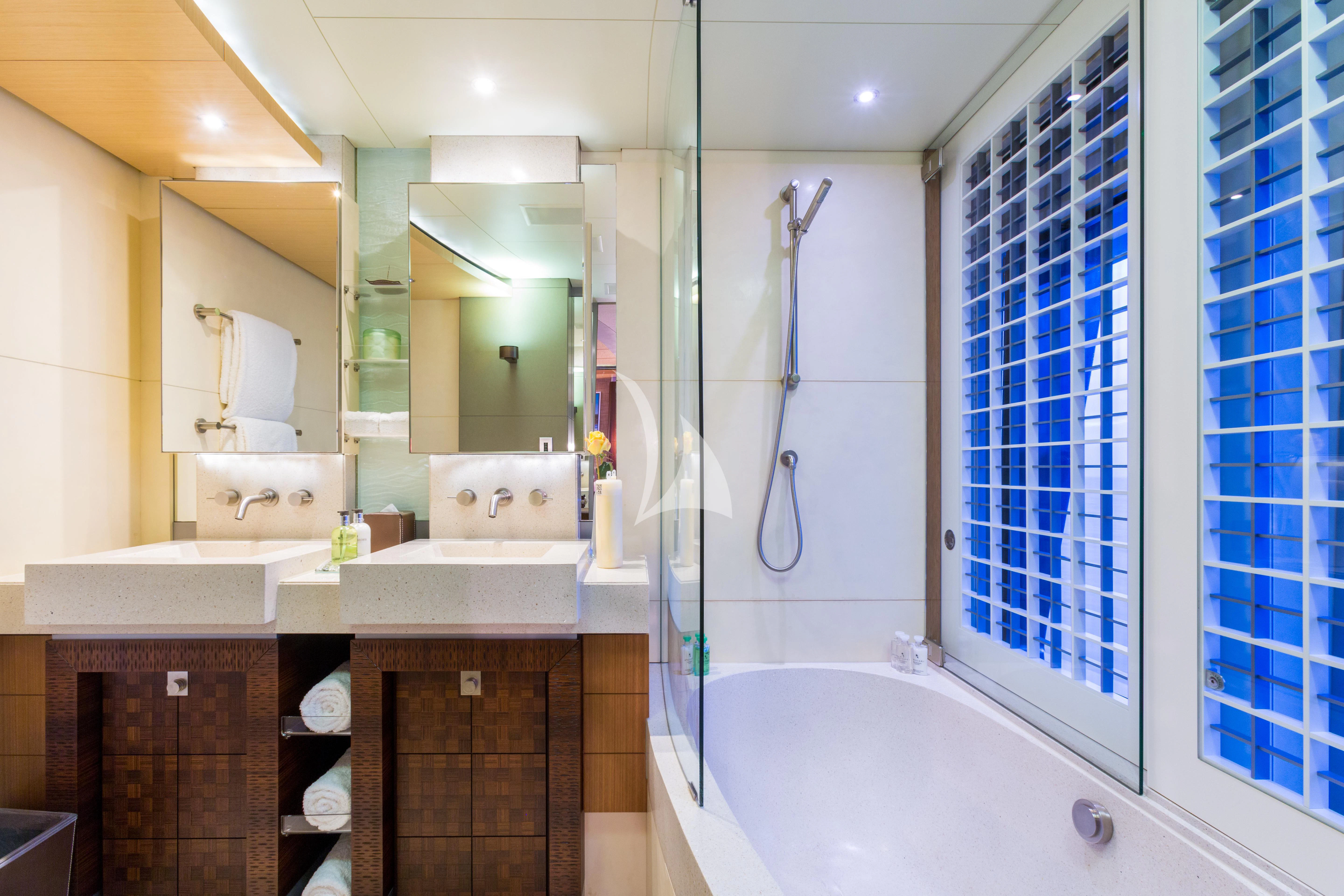 a bathroom with a tub and shower aboard WHEELS Yacht for Sale