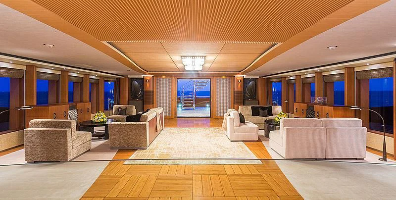 a large living room with white couches and a wood floor aboard WHEELS Yacht for Sale