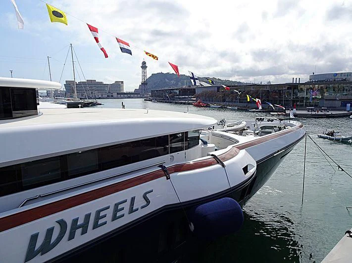 a boat docked at a pier aboard WHEELS Yacht for Sale