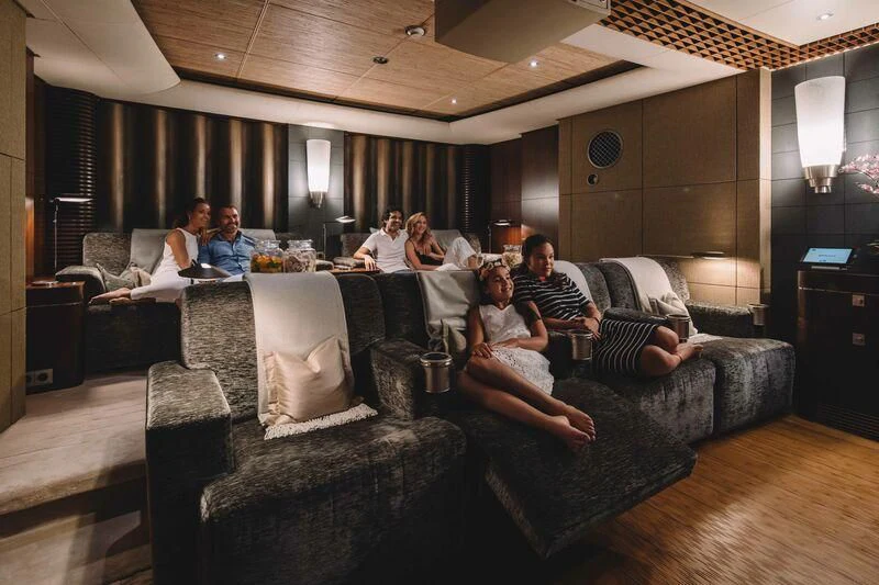 a group of people sitting in a living room aboard WHEELS Yacht for Sale