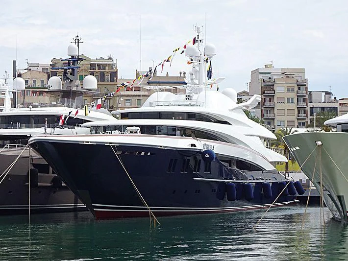 a large white boat sits in the water aboard WHEELS Yacht for Sale